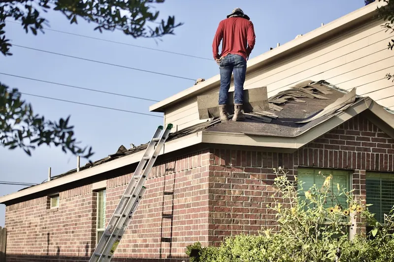 Professional roofer working on a residential roof in Rock Hall